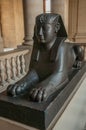 Ancient sculpture of Egyptian sphinx sitting at the Louvre Museum in Paris.